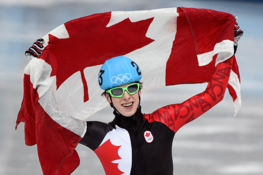 Canada's Charle Cournoyer celebrates after winning the bronze medal in the men's 500 metre final at the Sochi 2014 Olympic Winter Games Friday, February 21, 2014 in Sochi. THE CANADIAN PRESS/Paul Chiasson