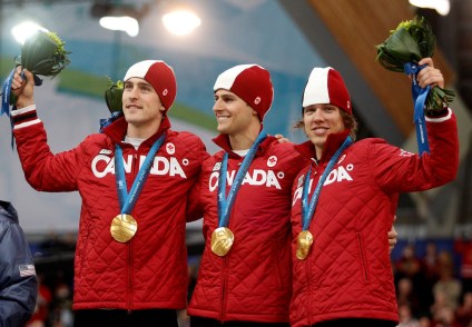 Team Canada's Denny Morrison, left, Lucas Makowsky, center, and Mathieu Giroux, right, are seen on the podium after winning the gold medal in the men's team pursuit final speed skating race at the Richmond Olympic Oval at the Vancouver 2010 Olympic Winter Games in Vancouver, British Columbia, Saturday, Feb. 27, 2010. (AP Photo/Matt Dunham)