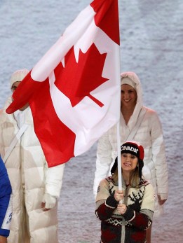 Women's figure skating bronze medallist Joannie Rochette carries the Canadian flag into the Vancouver 2010 Olympic Winter Games closing ceremony on Sunday, Feb. 28, 2010 at B.C. Place in Vancouver. THE CANADIAN PRESS/Nathan Denette