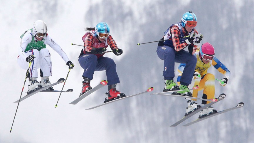 Marielle Thompson (middle right) and Kelsey Serwa (middle left) fly through the air before finishing 1-2 in ski cross.