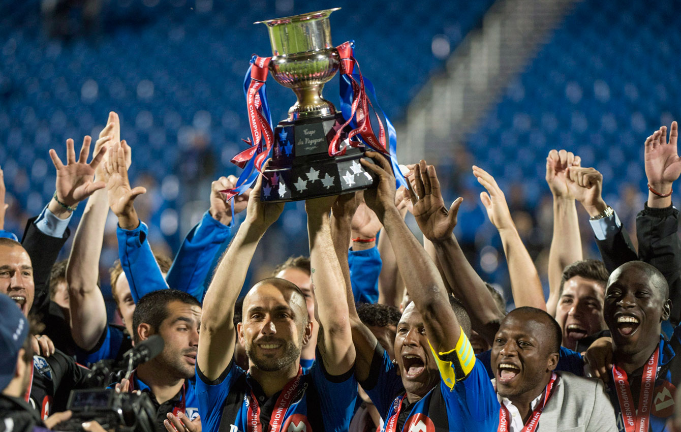 Patrice Bernier (with yellow captain's armband) lifts the Voyageurs Cup that allowed Montreal a chance at the CONCACAF Champions League crown. 