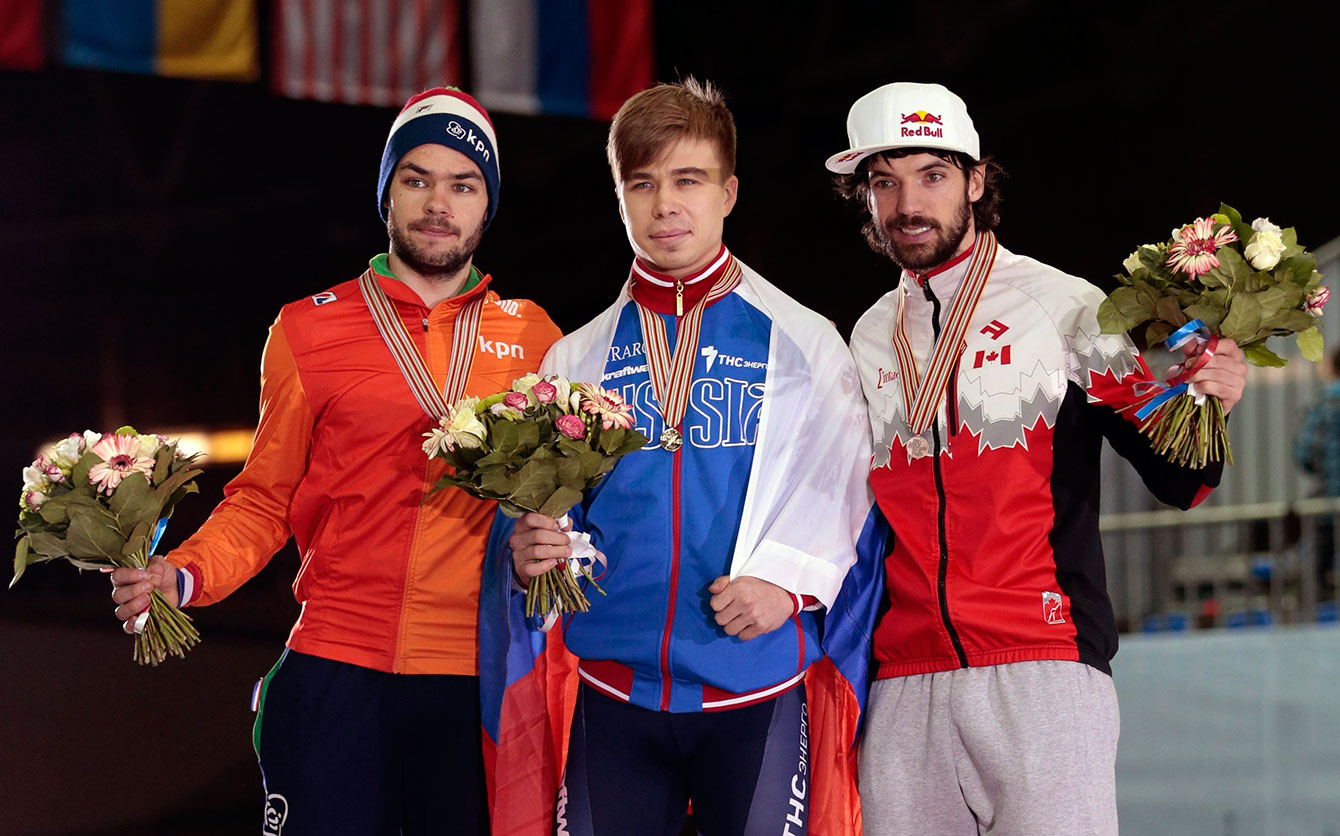 From left, silver medallist Sjinkie Knegt of the Netherlands, gold medallist Semen Elistratov of Russia, and bronze medallist Charles Hamelin of Canada, pose with their medals during the short track world championships, in Moscow, Russia, on Saturday, March 14, 2015. (AP Photo/Ivan Sekretarev)