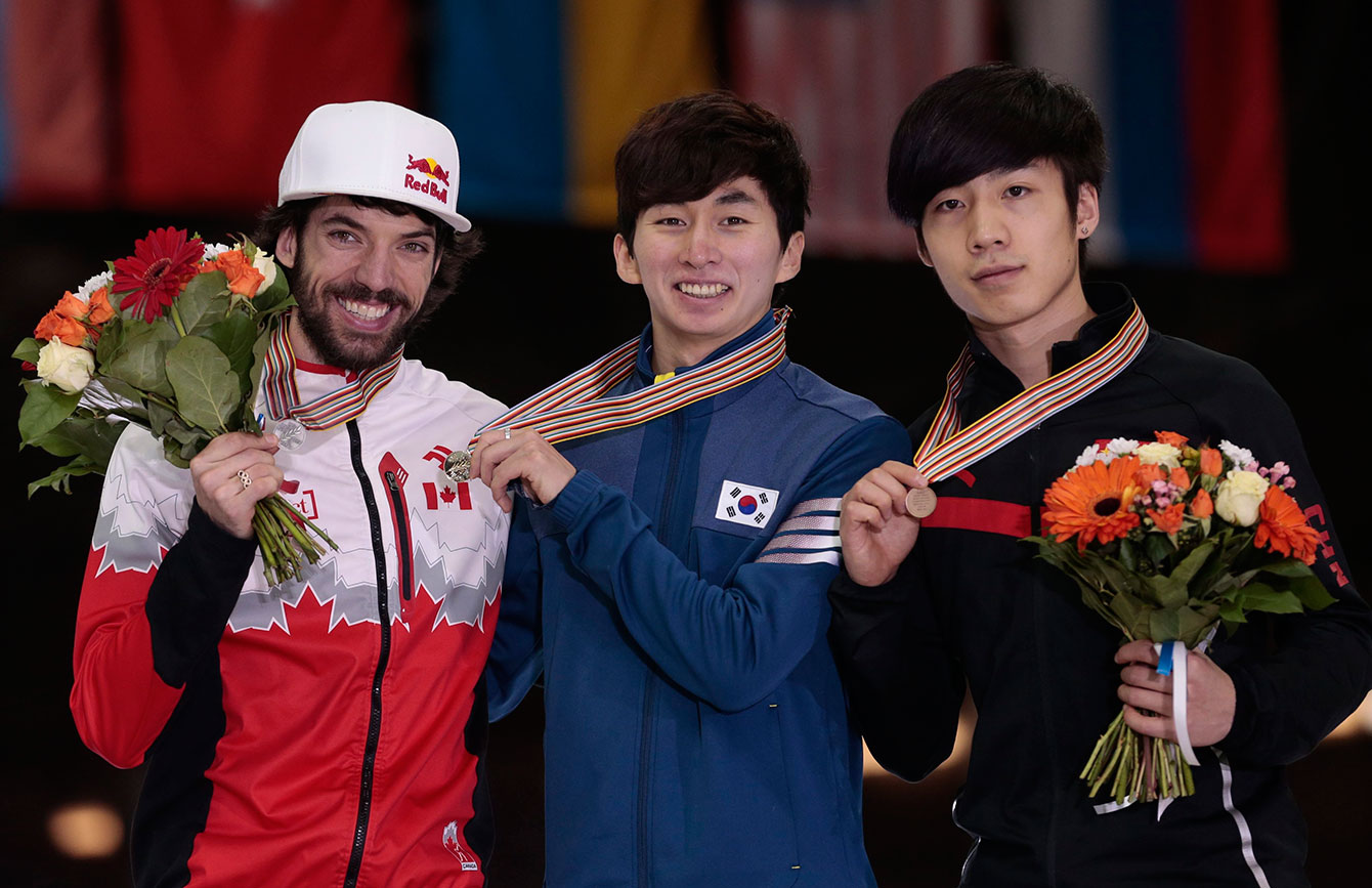 From left, silver medallist Charles Hamelin, of Canada, gold medallist Park Se Yeong, of Korea, and bronze medallist Shi Jingnan, of China, pose with their medals for men's the  1000m race at the short track world championships, in Moscow, Russia, on Sunday, March 15, 2015. (AP Photo/Ivan Sekretarev)