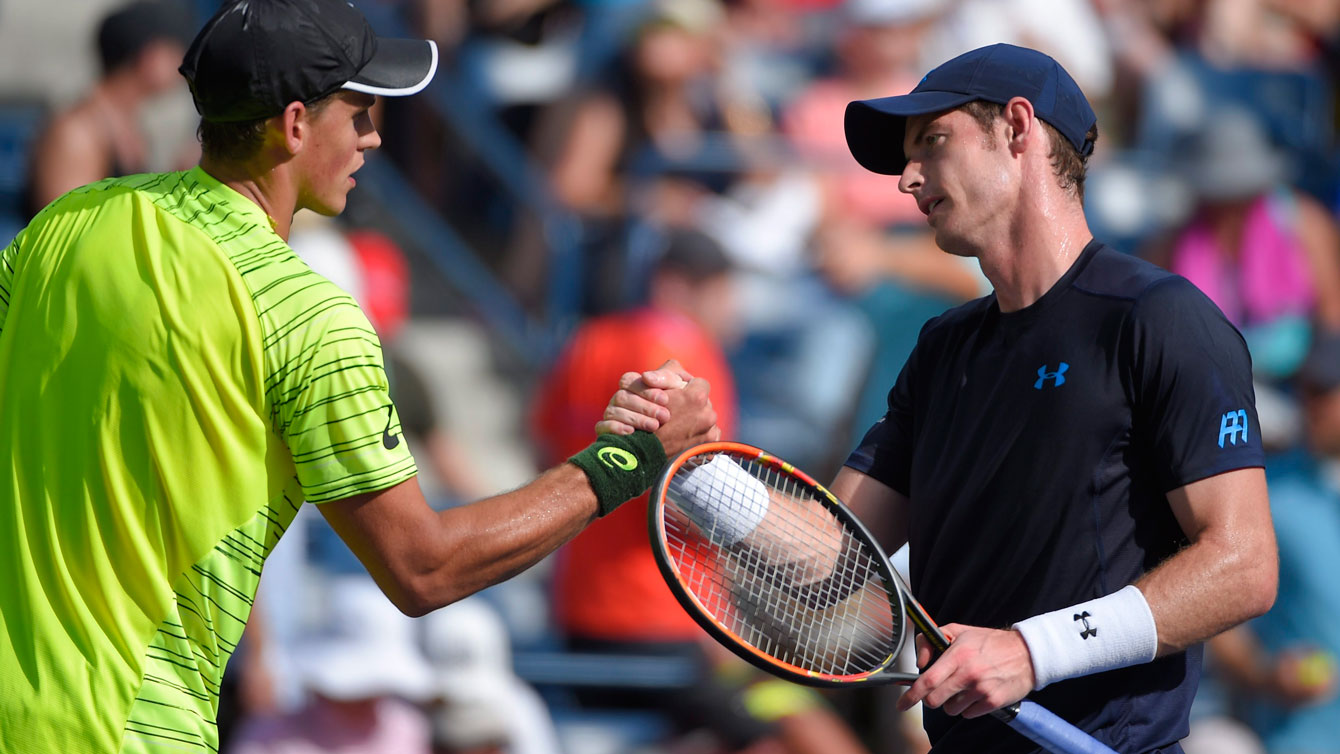 Vasek Pospisil left shakes hands with Andy Murray at the net after their singles match at Indian Well, California in March 2015.