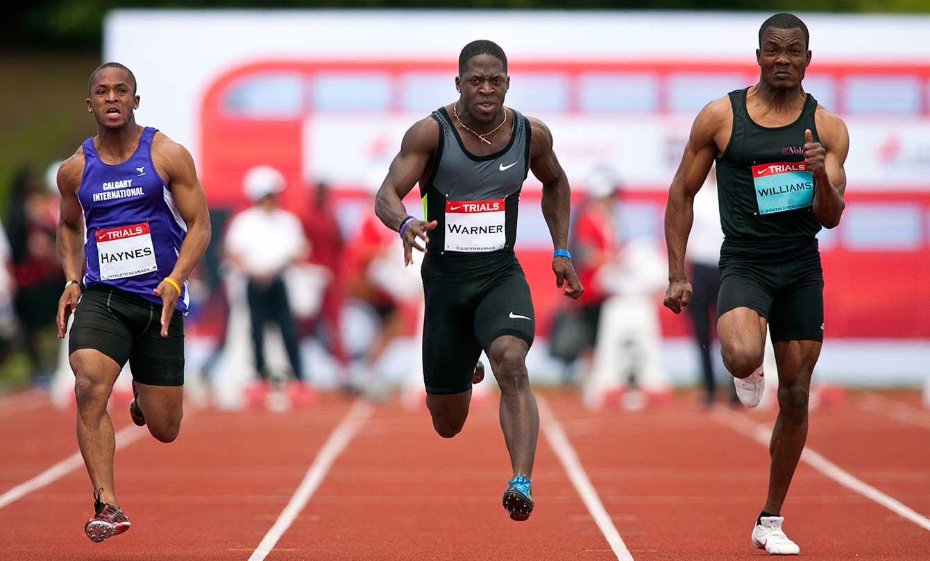 Olympian Justyn Warner (centre) runs in the men's 100m at Canadian Track and Field Championships in Calgary, Alta., Friday, June 29, 2012.THE CANADIAN PRESS/Jeff McIntosh