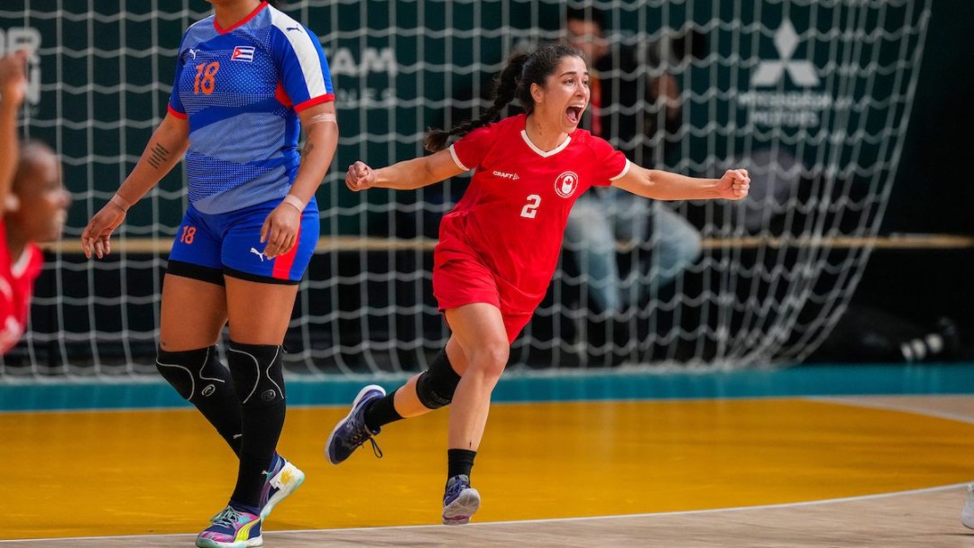 Nassima Benhacine celebrates as she runs across the court