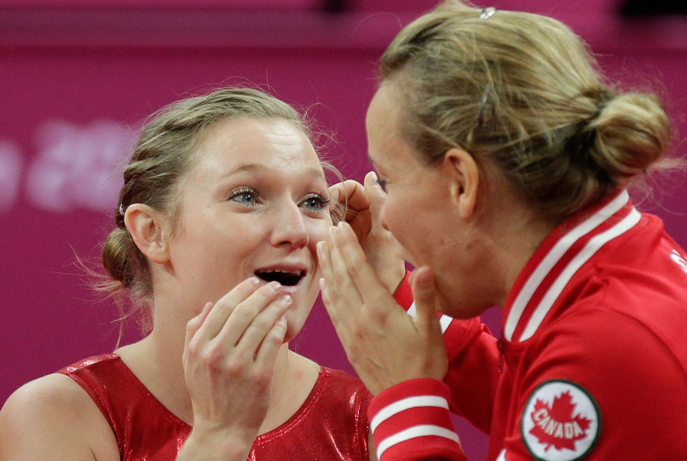 Rosie MacLennan and Karen Cockburn react as gold medal scores arrive at London 2012.