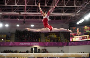 Victoria Woo of Canada competes in the balance beam portion