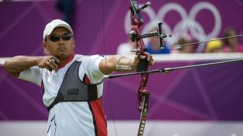 Crispin Duenas fires an arrow from his bow