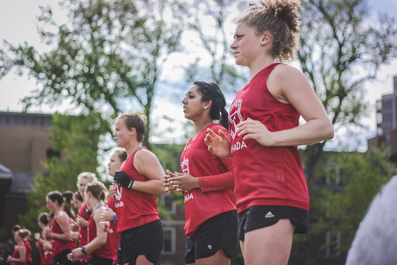 Members of the national field hockey team warm-up prior to training, May 21, 2015. (Photo: Alexa Fernando)