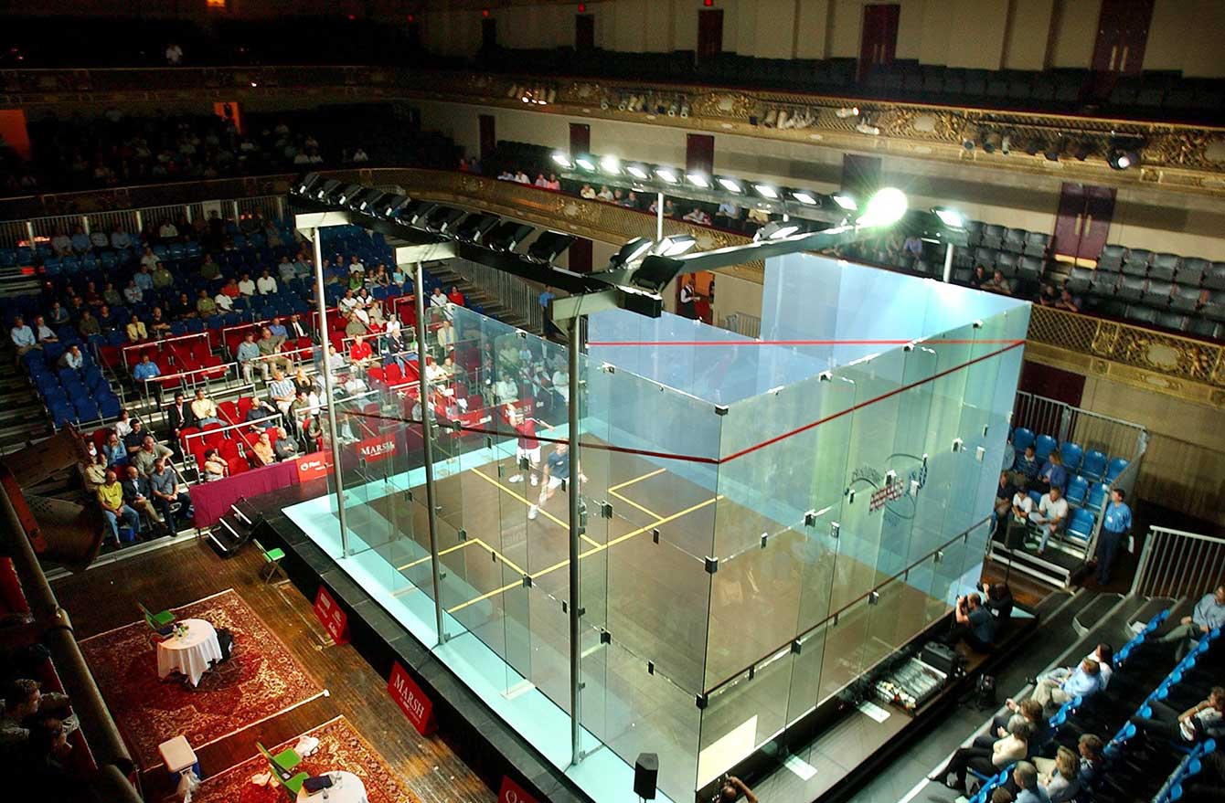 Stewart Boswell of Australia (blue shirt) and Jonathon Power of Canada playing a quarterfinal match of the U.S. Open squash tournament, (2002). (AP Photo/Adam Hunger)