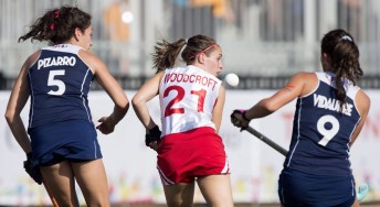Amanda Woodcroft, centre, of Canada, tracks the ball between Chile's Francisca Pizarro, left, and Francisca Vidaurre during the bronze