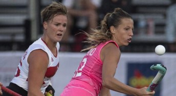 Argentina's Delfina Merino (right) bounces the ball on her stick as she takes it away from Canada's Shanlee Johnston