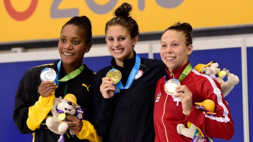 Gold medalist Katie Meili of the USA, centre, silver medalist Alia Atkinson of Jamaica, left, and bronze medalist Rachel Nicol of Canada pose with their medals in the women's 100m breaststroke final swimming event at the 2015 Pan Am Games in Toronto.