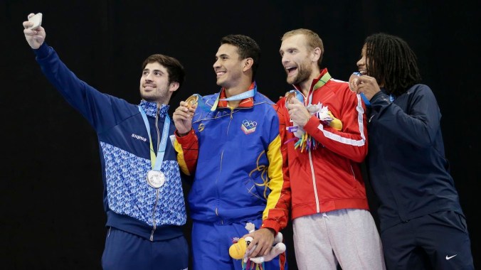 Epee fencing medallists pose for a selfie