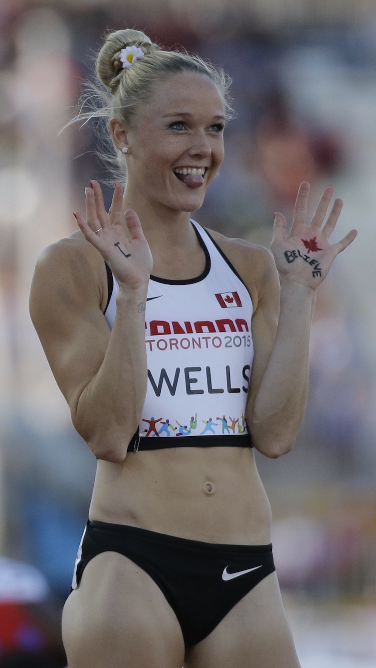 Sarah Wells, of Canada, waves to a camera before running in the finals