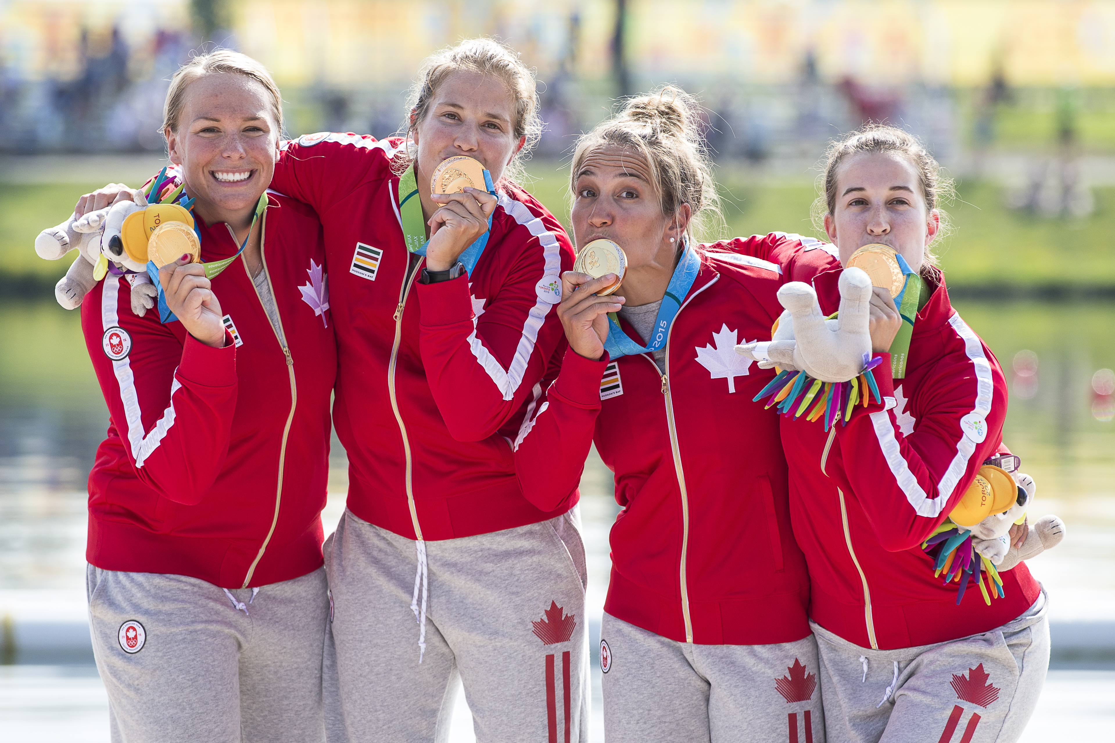Members of Canada's K4 500m team celebrate winning the first gold medal of the Pan Am Games in Toronto
