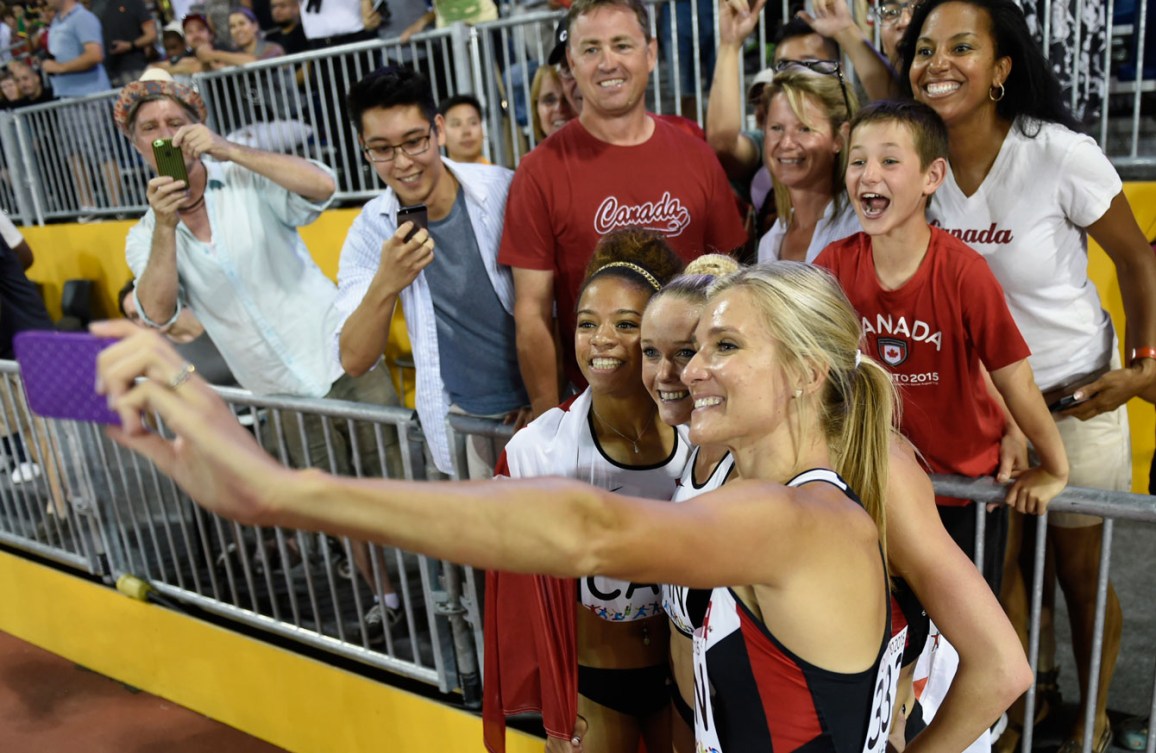 Canada's 4x400 women's team takes a selfie with fans while celebrating their TO2015 bronze from Day 15.