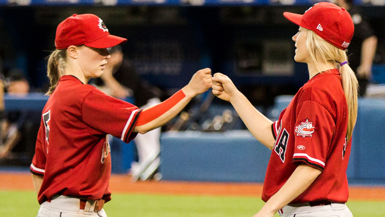 Team Canada members give a fist bump during a match at TO2015