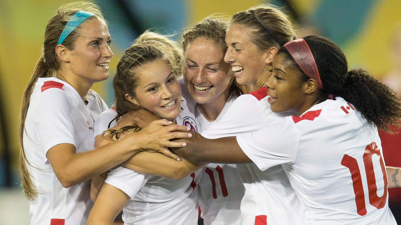 Members of the Canada women's football team celebrate one of Janine Beckie's goals in a 5-2 Pan Am Games win over Ecuador on July 11, 2015.
