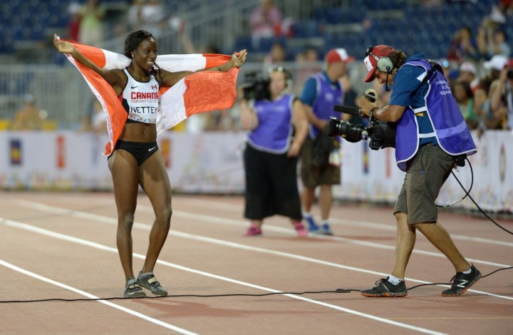 Christabel Nettey celebrating with the Canadian flag