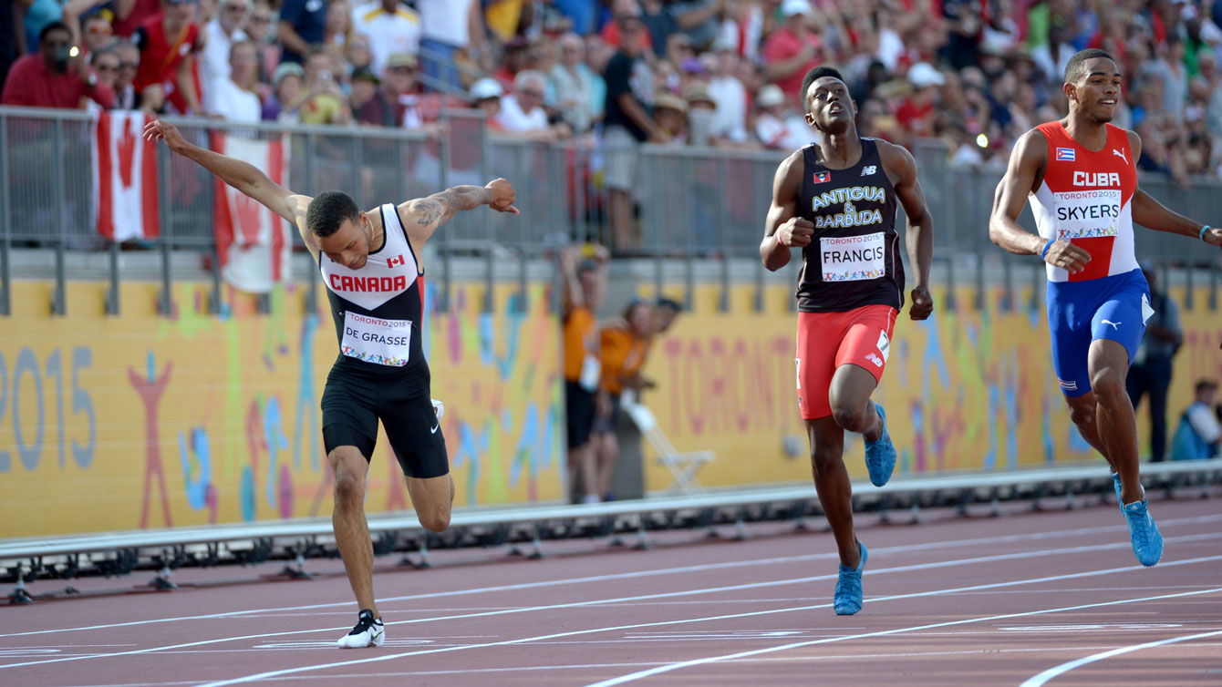 Andre De Grasse leans in to take the 200m Pan Am Games title from Lane 8 in Toronto on July 24, 2015.