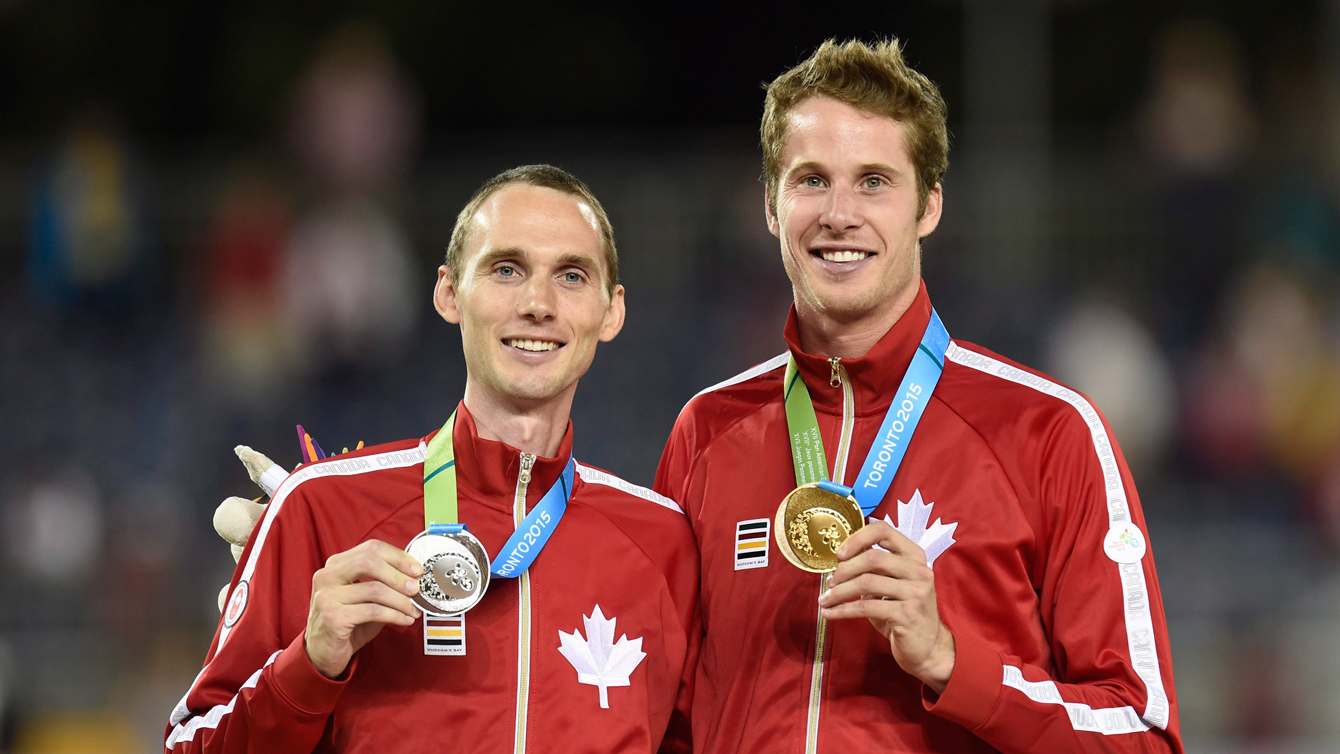 Derek Drouin (right) and Mike Mason (left) celebrate after the men's high jump final at the 2015 Pan Am Games on July 25, 2015. (THE CANADIAN PRESS/Frank Gunn)