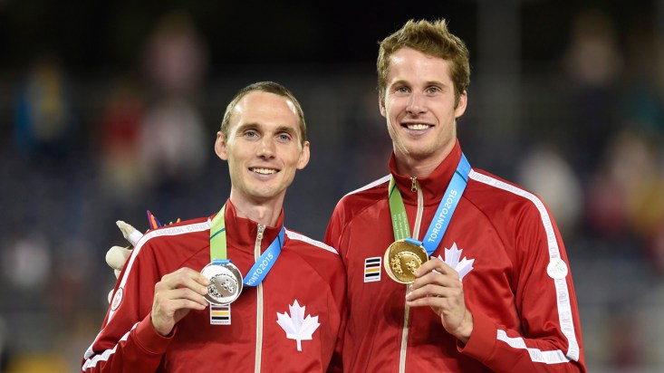 Derek Drouin (right) and Mike Mason (left) celebrate gold and silver after the men's high jump final at the 2015 Pan Am Games on July 25, 2015. (THE CANADIAN PRESS/Frank Gunn)