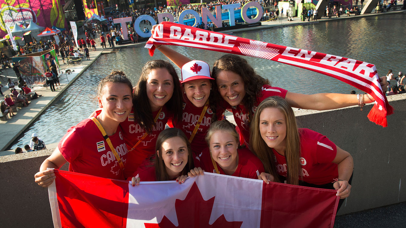 Members of the field hockey team pose with the new Toronto sign in the background on the eve of TO2015 Pan American Games (Photo: Jason Ransom/COC).