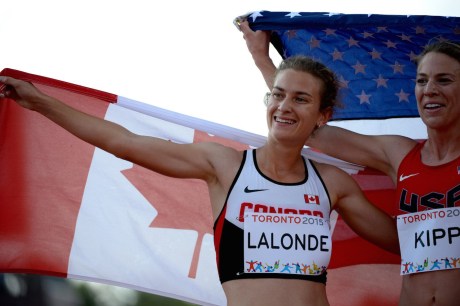 Genevieve Lalonde celebrating with the Canadian flag