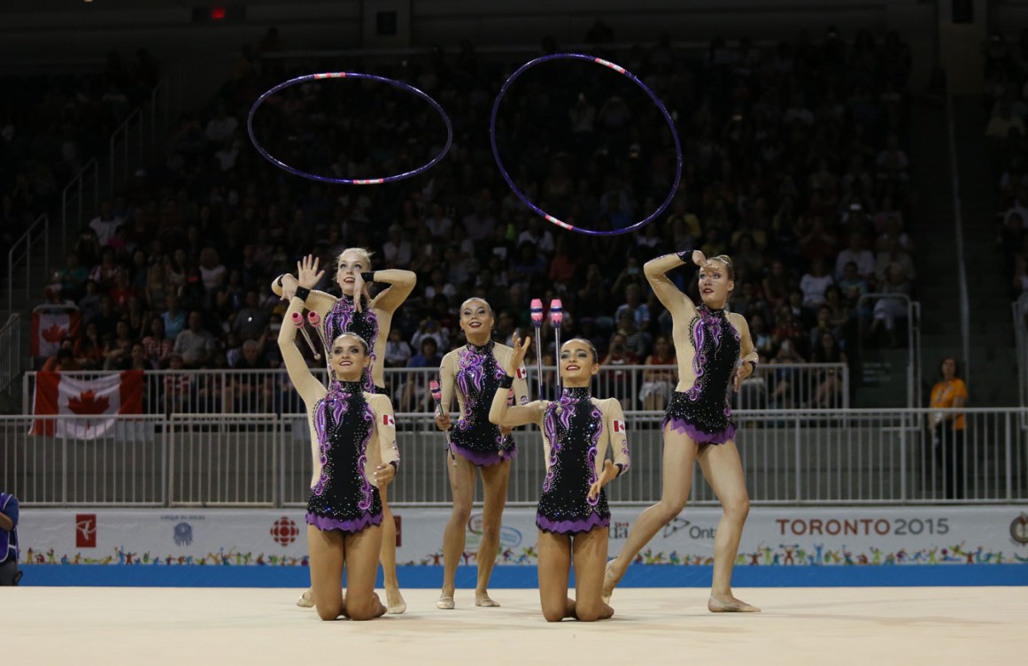 The group of Katrina Cameron, Lucinda Nowell, Vanessa Panov, Maya Kojevnikov, Anjelika Reznik and Victoria Reznik took bronze in the group clubs/hoops event at Toronto 2015 on July 20, 2015.