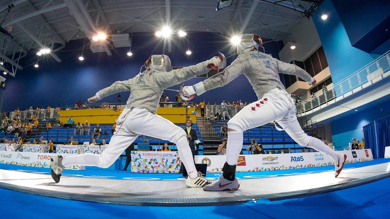 Joseph Polossifakis (Canada) fences against Stryker Weller of the Virgin Islands in the initial elimination rounds of Men's Sabre Competition at the Pan-American Games in Toronto, Canada.