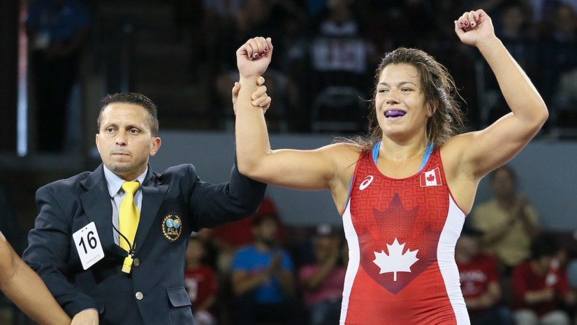 Justine Di Satsio (red) of Coquitlam, B.C. defeated Lisset Hechavarria of Cuba in the freestyle wrestling 75 kg.