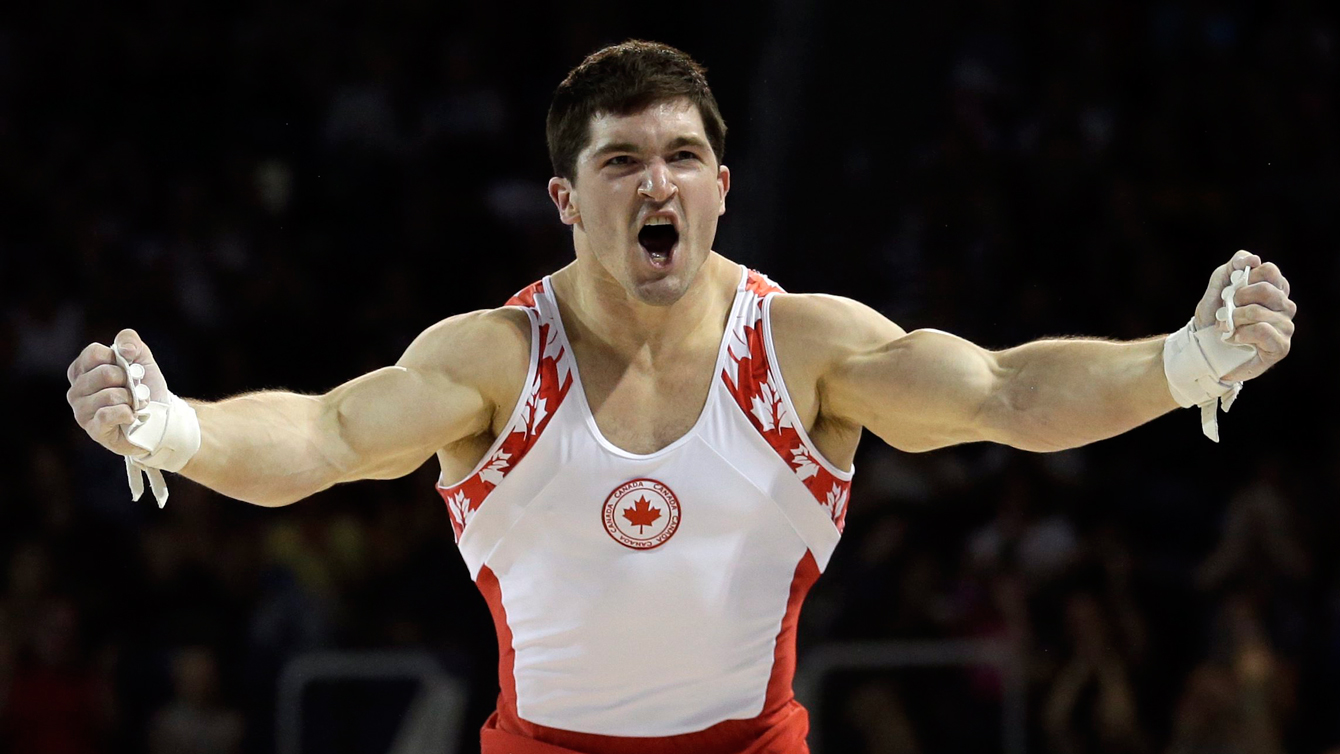 Kevin Lytwyn reacts after finishing his artistic gymnastics horizontal bar routine at the Pan Am Games on July 15, 2015. (Photo/Gregory Bull)