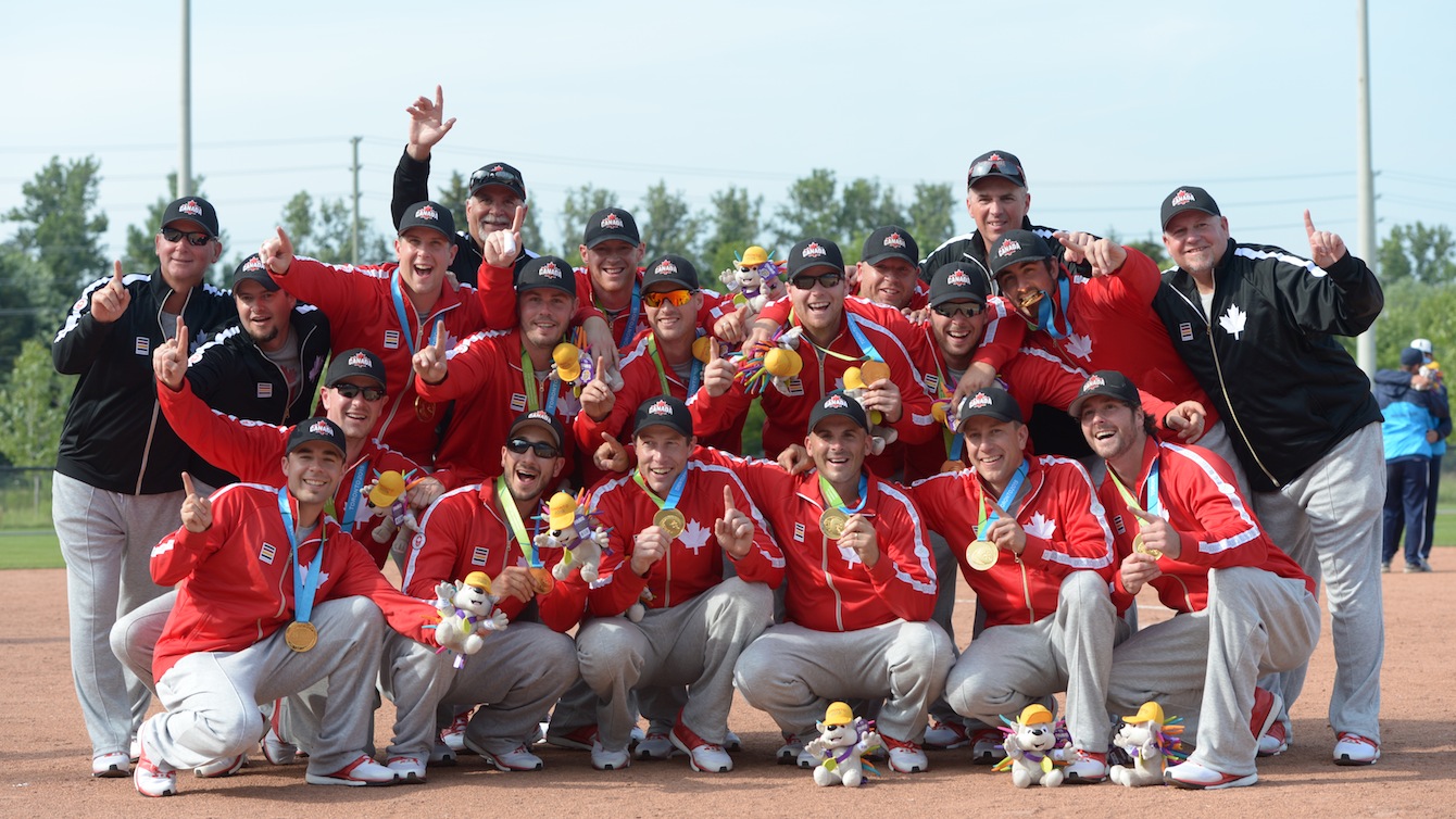 Men's softball team poses with their medals