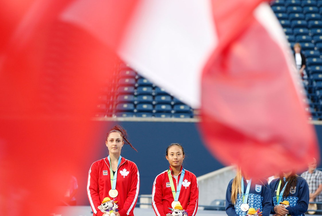 Gabriela Dabrowski (left) and Carol Zhao listen to O'Canada after winning women's doubles gold. (Photo: David Jackson)