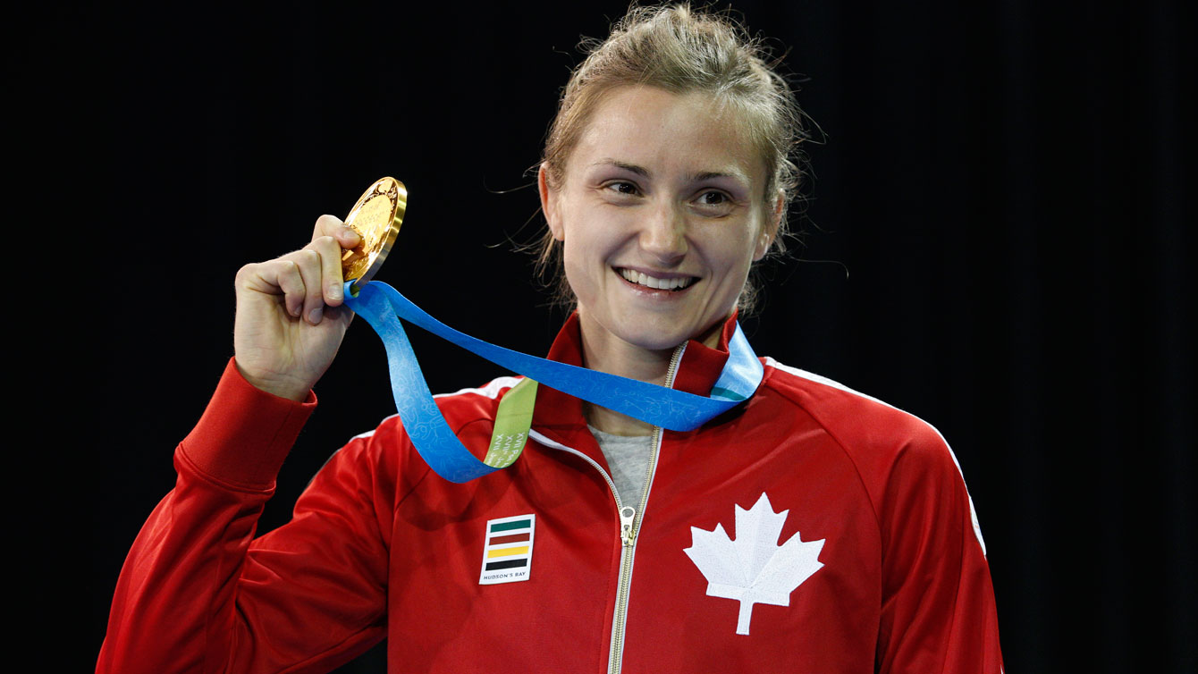 Genvieve Morrison holds up her Pan Am Games wrestling gold medal on July 16, 2015. 
