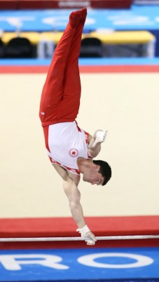 Kevin Lytwyn of Stoney Creek, Ont. in his silver medal routine in horizontal bar artistic gymnastics competition at the PanAmerican Games in Toronto, Wednesday, July 15, 2015. Photo by Mike Ridewood/COC