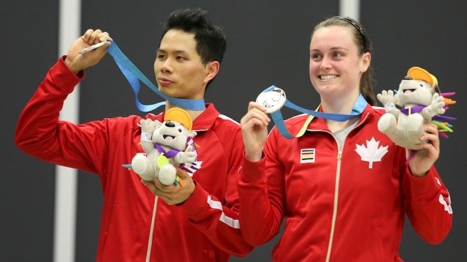 Alex Bruce (right) of Toronto and Toby Ng of Vancouver show off their silver medal in mixed doubles badminton finals play at the PanAmerican Games in Markham, Ont. Photo by Mike Ridewood