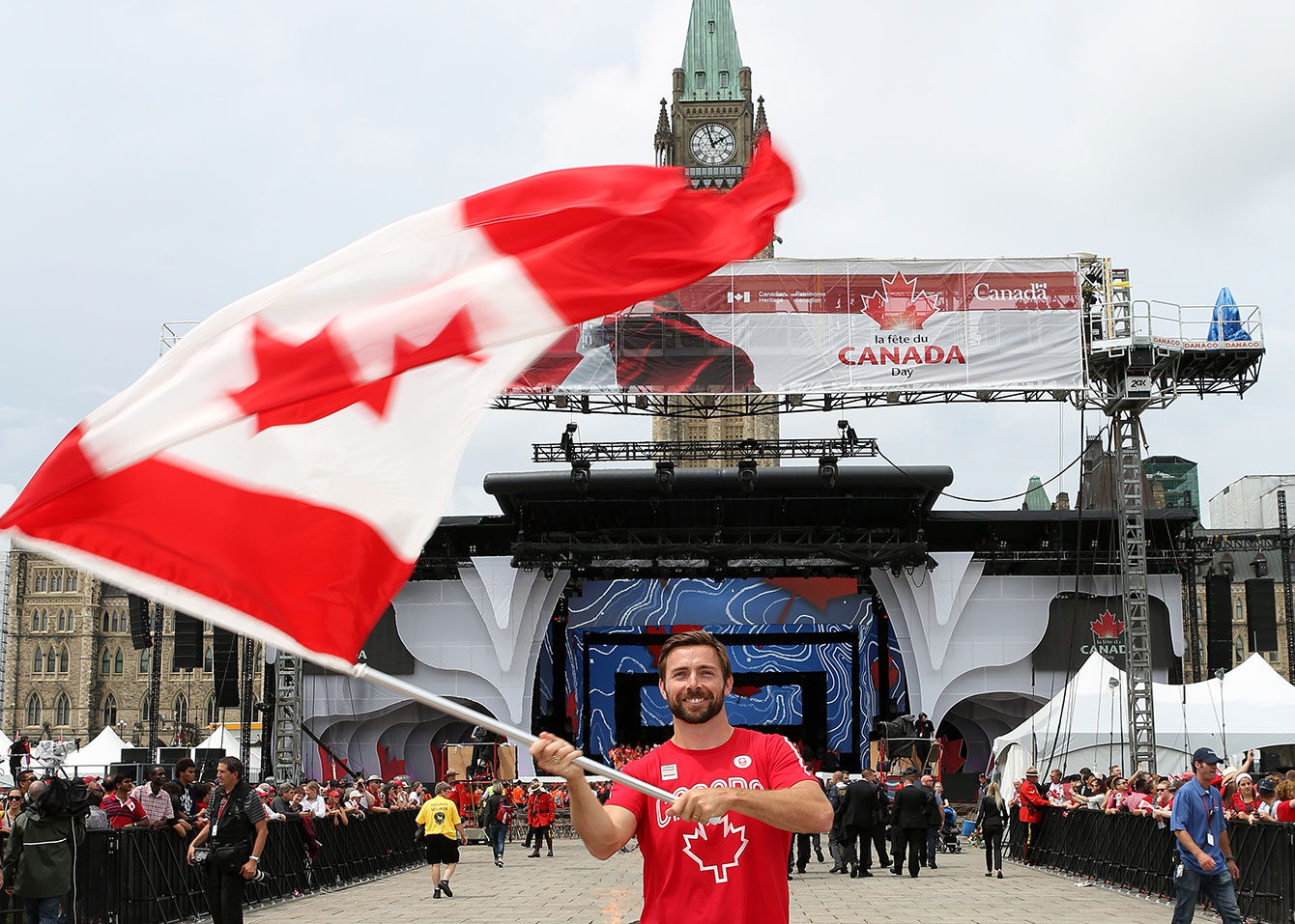 Mark Oldershaw waves the flag prior to Canada Day celebrations on Parliament Hill on July 1, 2015 (Greg Kolz for Canadian Olympic Team).