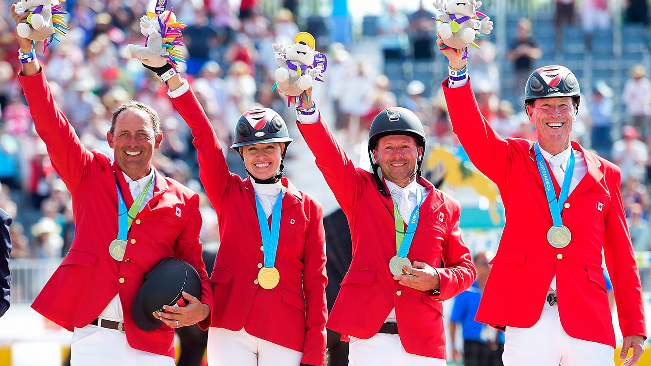 The show jumping team of (from left to right) Yann Candele, Tiffany Foster, Eric Lamaze and Ian Millar took TO2015 gold in the team jumping event on Day 13.