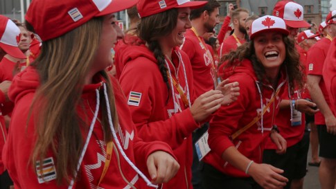 Members of the women's field hockey team at the athletes' village opening for Toronto 2015 Pan American Games in their Hudson's Bay hoodies and ball caps from the official kit.