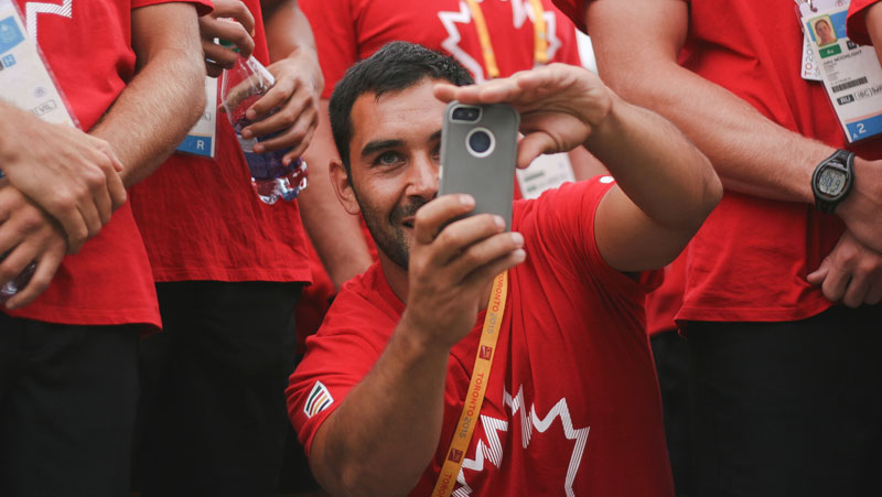 Rugby star Phil Mack turns the tables on photographer Alexandra Fernando at the TO2015 athletes' village welcoming (Photo: Alexandra Fernando). 