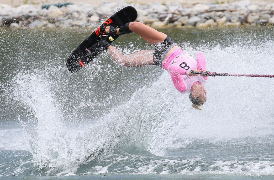 In the trick portion of the contest, the skiers do one pass while holding the bar with their hands and another with the bar attached to one of their feet.