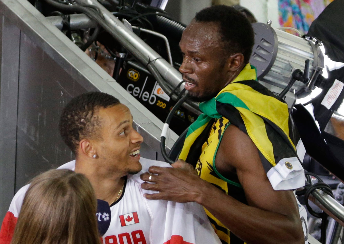 Usain Bolt and Andre De Grasse share a moment after both men won medals in the 100m at the 2015 IAAF World Championships on August 23, 2015 in Beijing, China. 