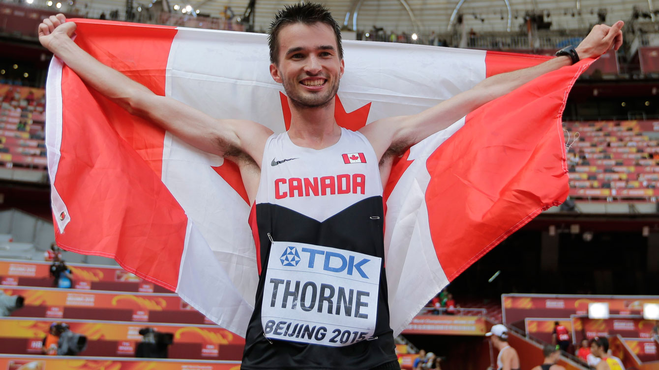Ben Thorne holds up the maple leaf after winning IAAF World Championship in Athletics bronze medal in 20km race walk on August 23, 2015 in Beijing, China.