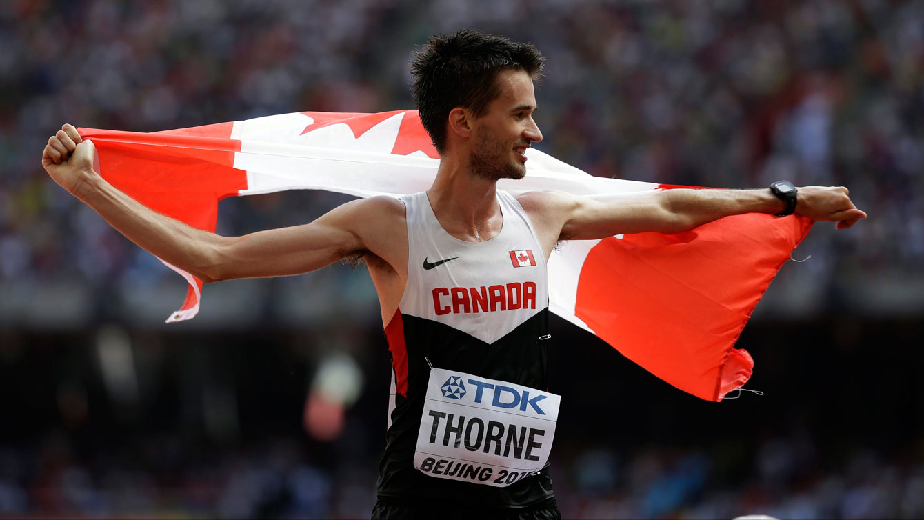 Ben Thorne holds up the maple leaf after winning IAAF World Championship in Athletics bronze medal in 20km race walk on August 23, 2015 in Beijing, China.