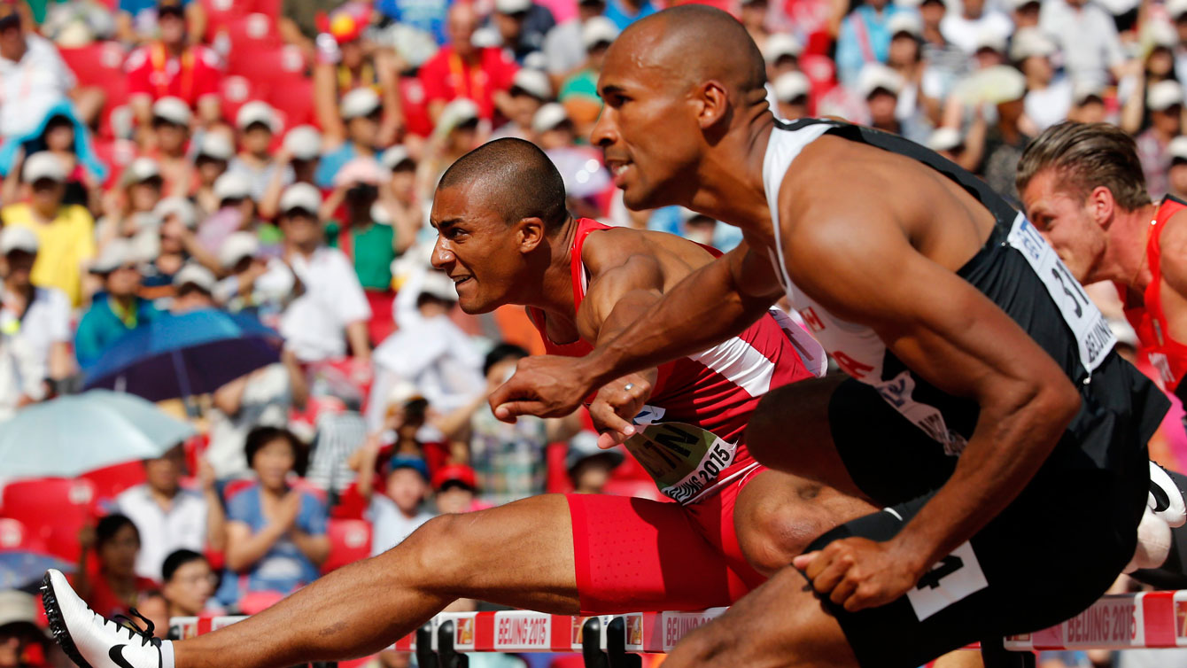 Ashton Eaton (left) and Damian Warner race in the 110m hurdles at the world championships in athletics on August 29, 2015. 
