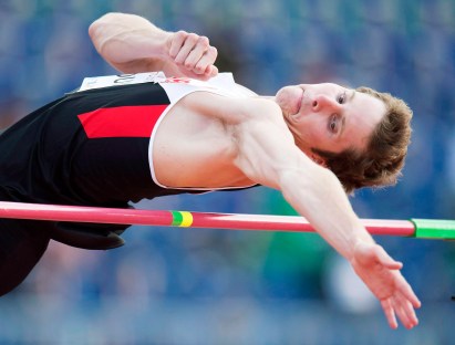 Derek Drouin clears the bar in the men's high jump final