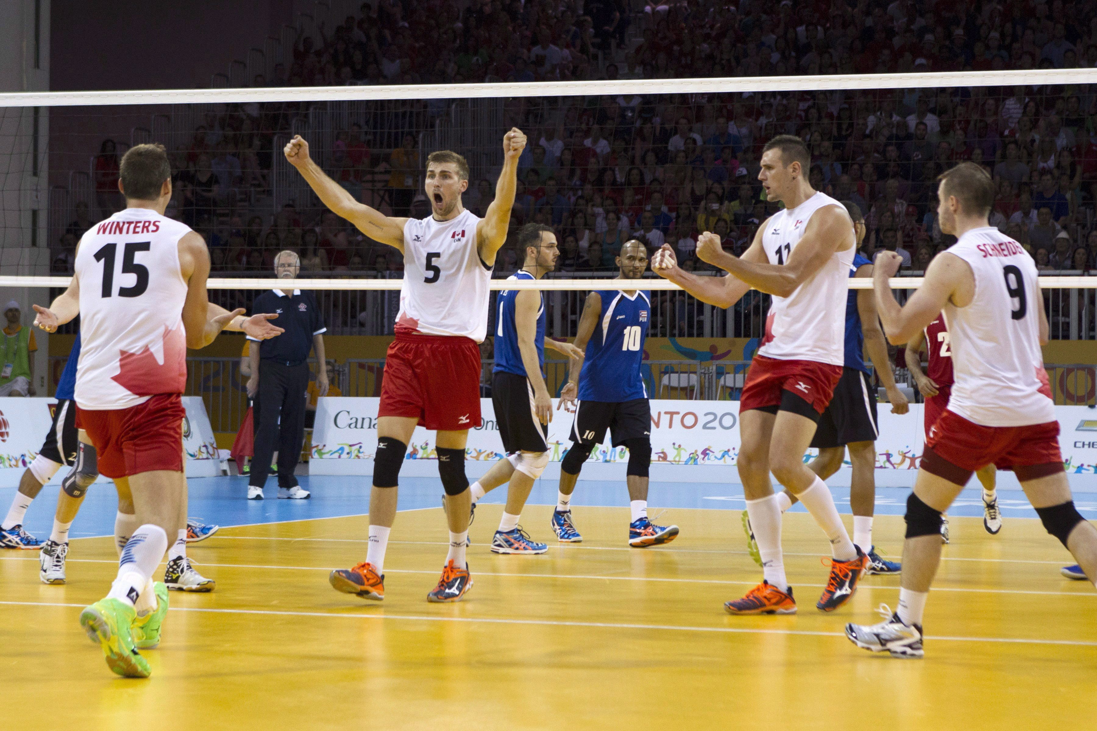 Members of the Canadian men's volleyball team celebrate a point during their 3-1 win over Puerto Rico in the men's volleyball bronze medal game at the Pan Am Toronto 2015 games in Toronto on Sunday, July 26, 2015. THE CANADIAN PRESS/Chris Young